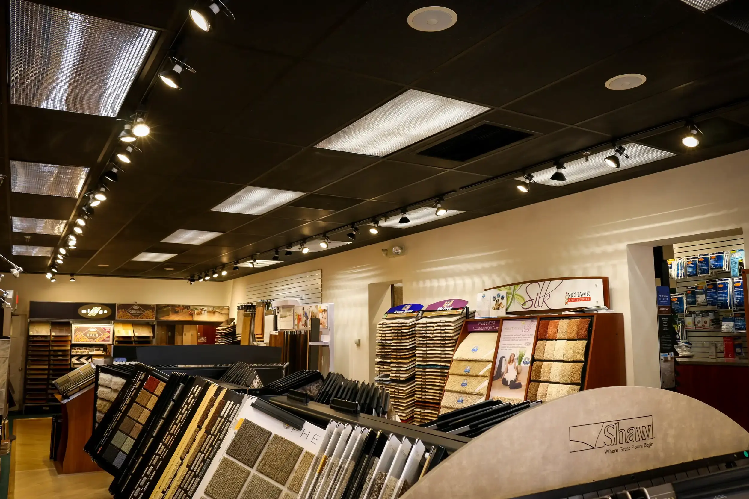 Carpet samples along the wall at the Olney showroom of Carpet & Vacuum Expo.