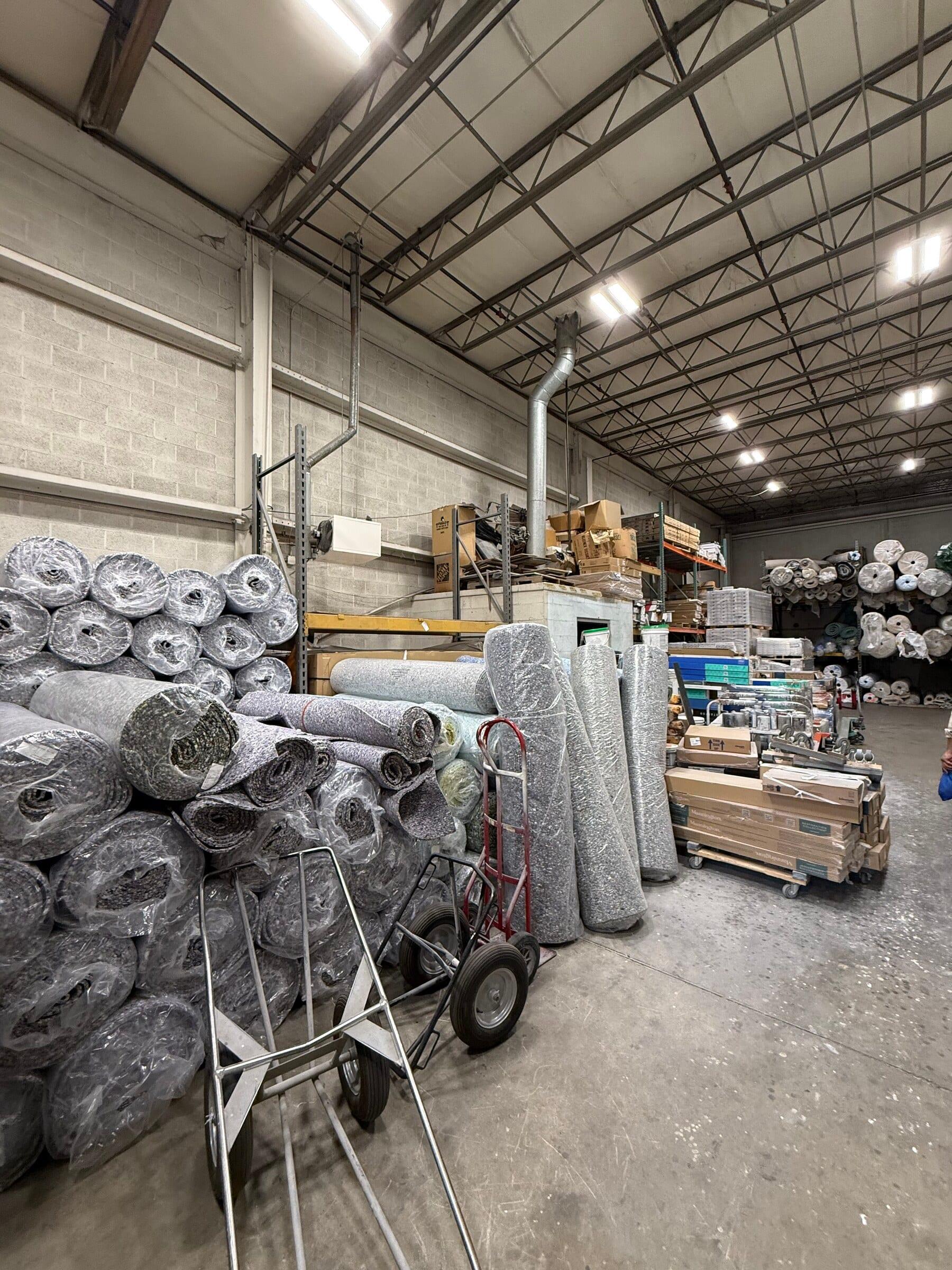 Rolls of carpet stacked in the Gaithersburg warehouse